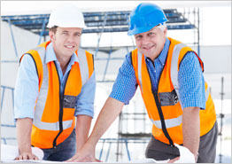 Workers in Hard Hats Standing at Table